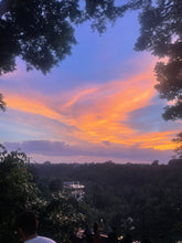 Breathtaking Bali sunset with golden clouds over the jungle canopy